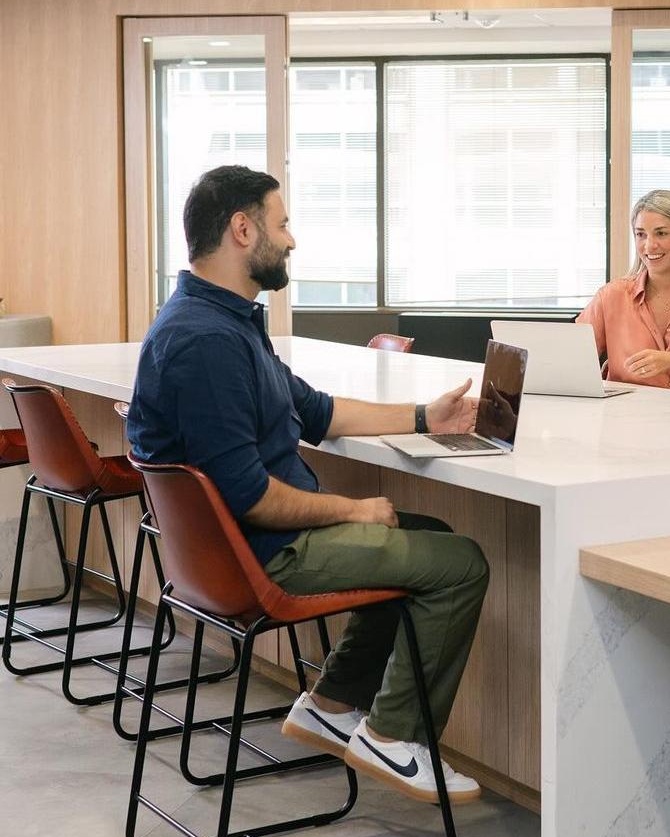 Abhishek in conversation at an office table