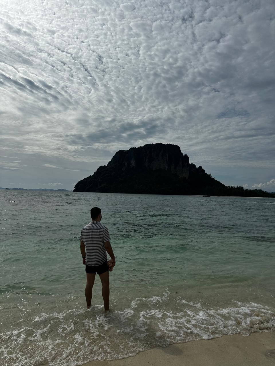 Abhishek looking across the sea towards a karst island